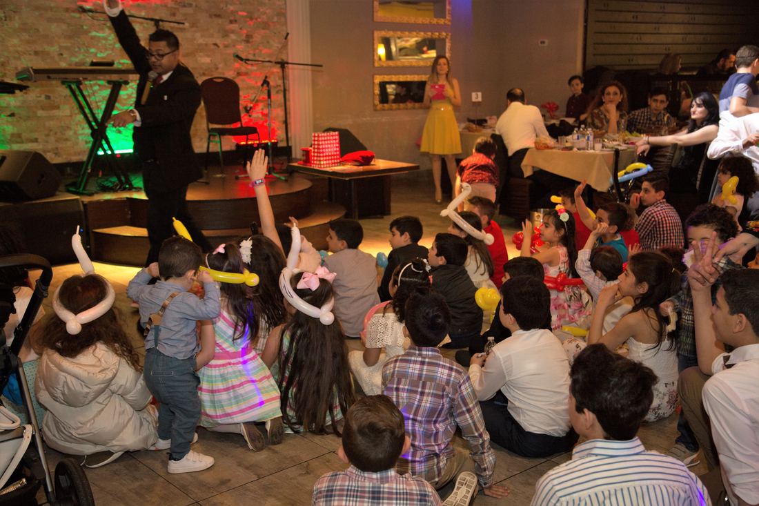 Full room watching a live performance